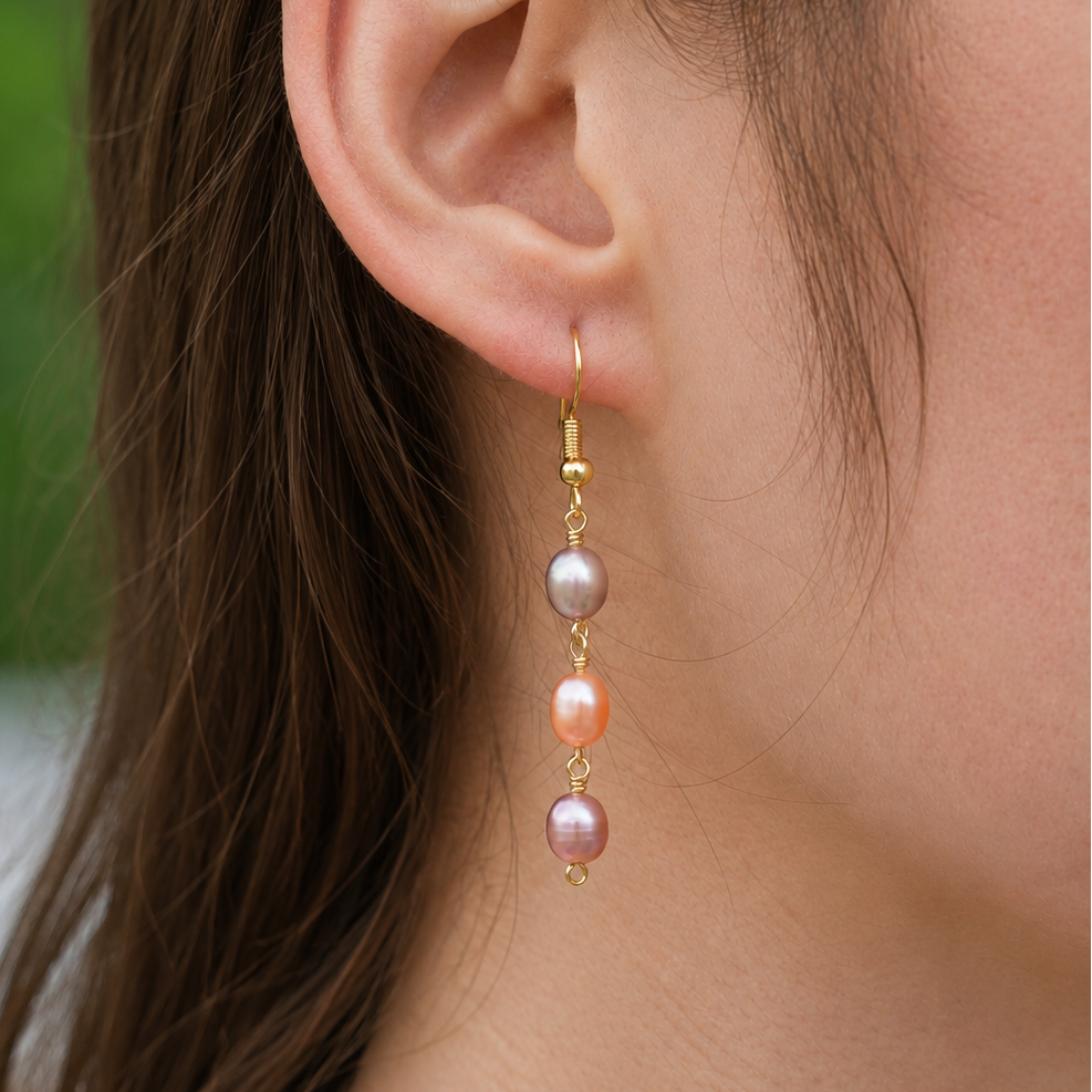 Afterglow Pearl Drop Earrings close-up with peach and mauve freshwater pearls