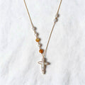 Aurelia Necklace with a cross-shaped freshwater baroque pearl and golden-lip mother-of-pearl beads on a 14k gold-filled chain