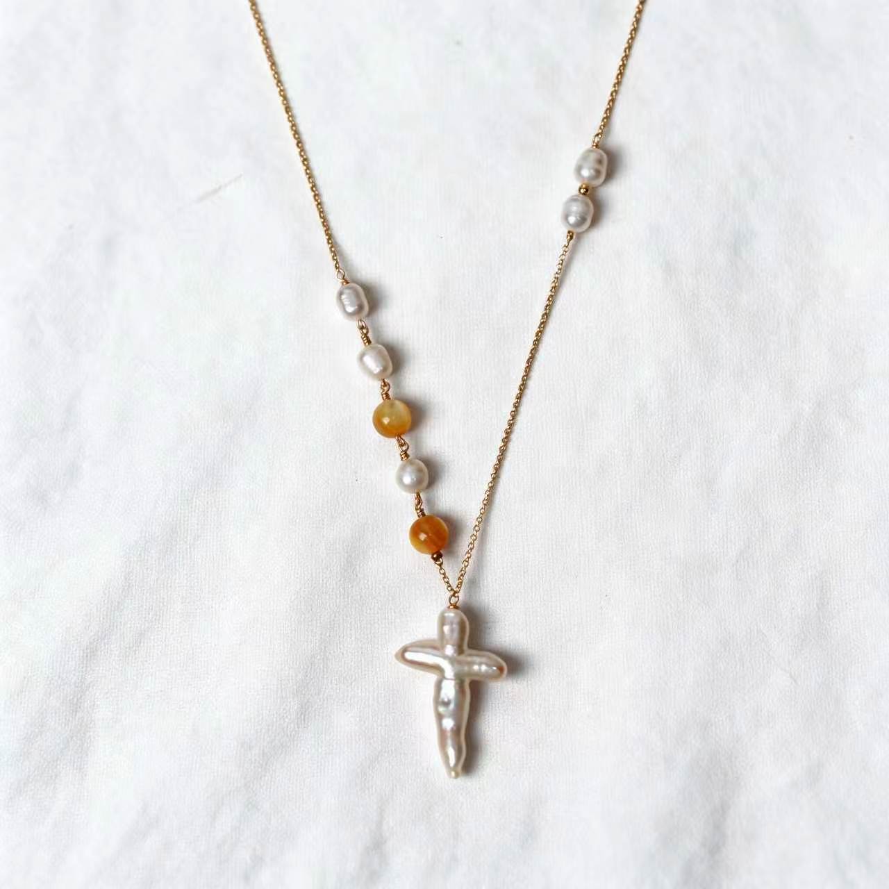 Aurelia Necklace with a cross-shaped freshwater baroque pearl and golden-lip mother-of-pearl beads on a 14k gold-filled chain