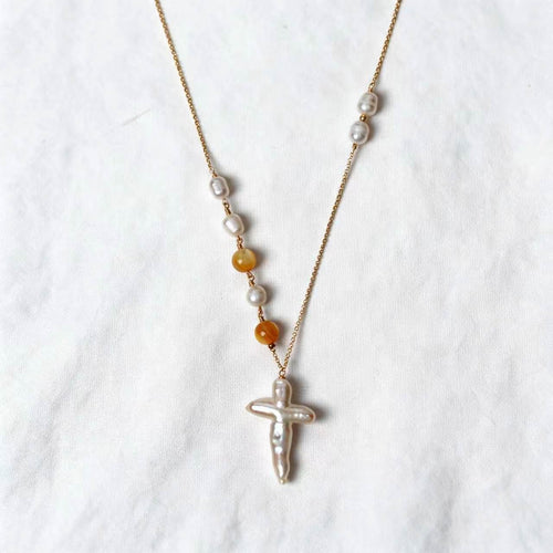 Aurelia Necklace with a cross-shaped freshwater baroque pearl and golden-lip mother-of-pearl beads on a 14k gold-filled chain