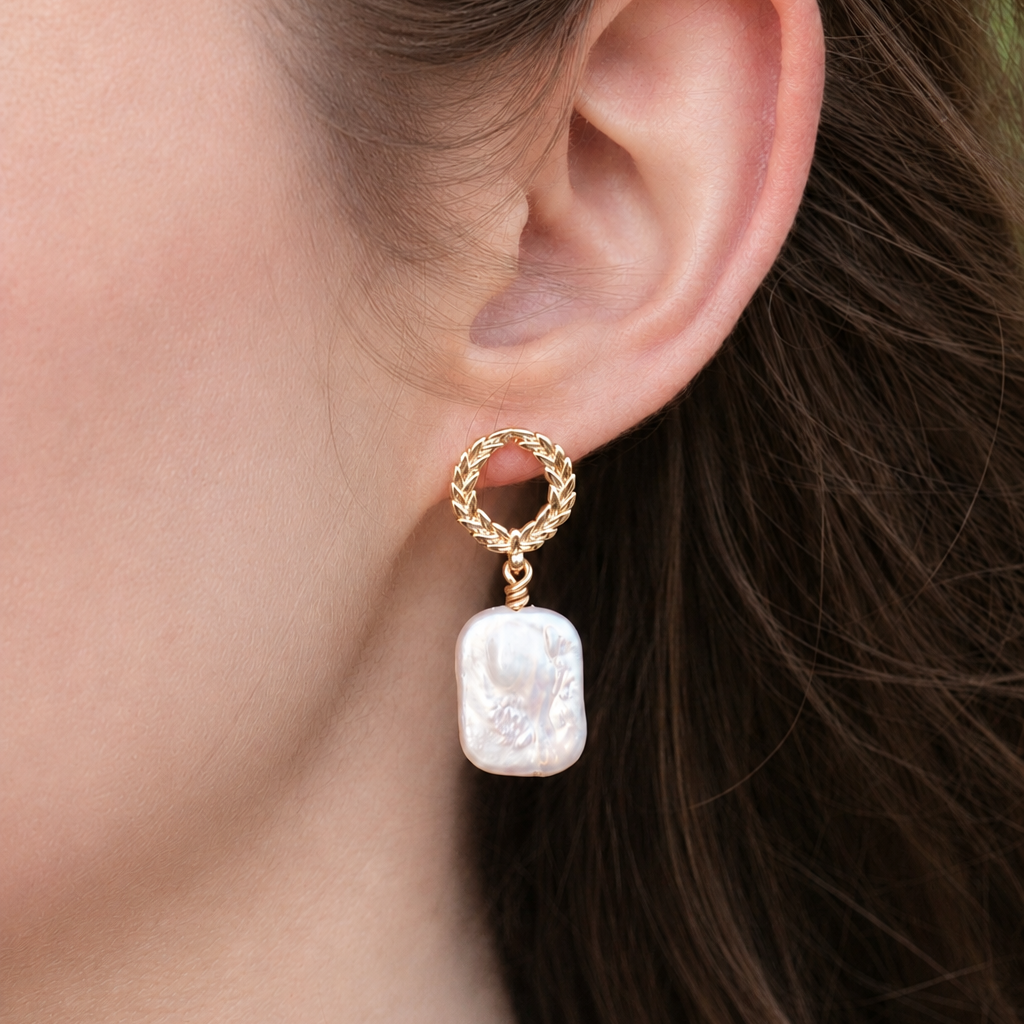 Laurel freshwater pearl drop earrings with 18k gold plated wreath detail worn on ear
