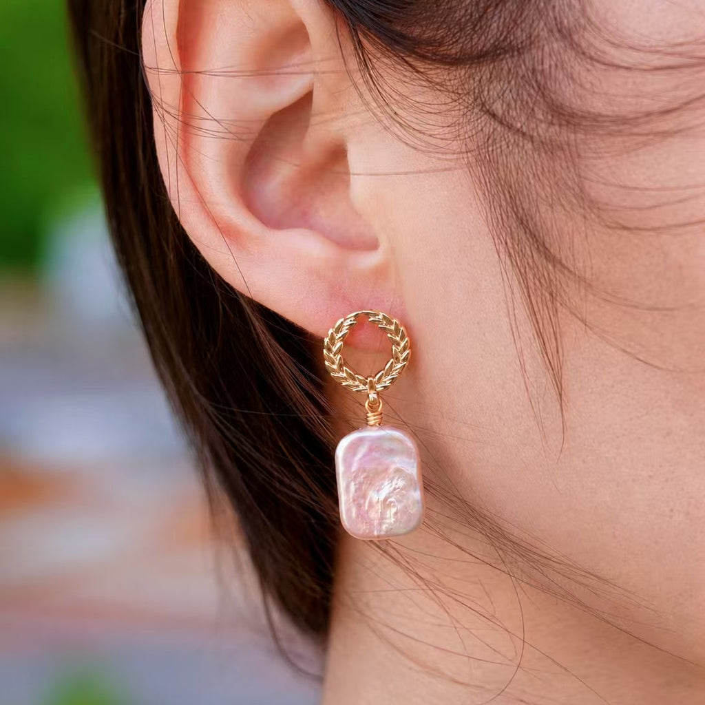 Laurel freshwater pearl drop earring close-up with gold wreath stud