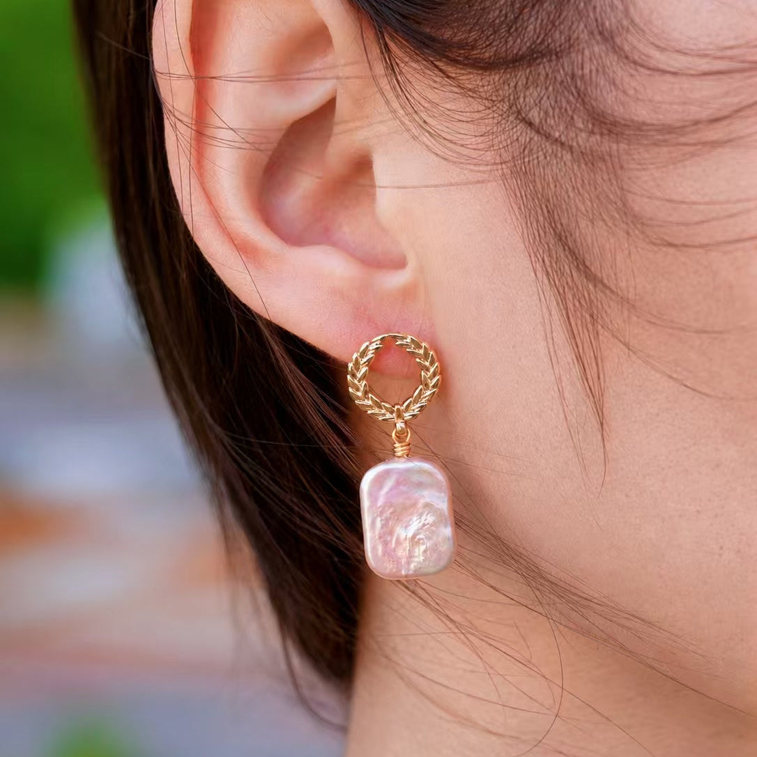 Laurel freshwater pearl drop earring close-up with gold wreath stud