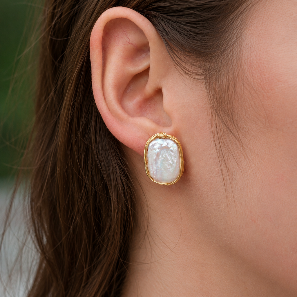 Close-up side view of Odette freshwater pearl wirework earrings
